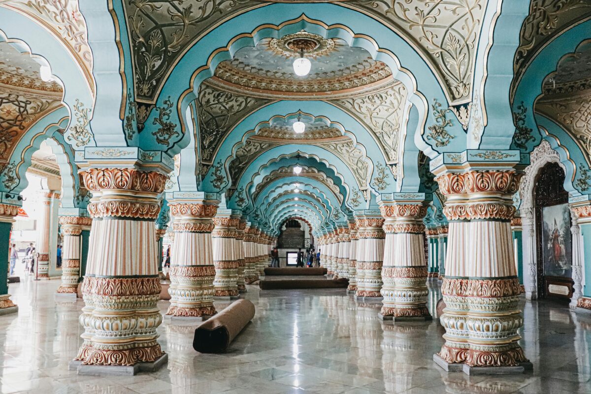 Interior of historical royal palace with ornamental ceiling and various decorated columns in audience hall located in Mysore in India